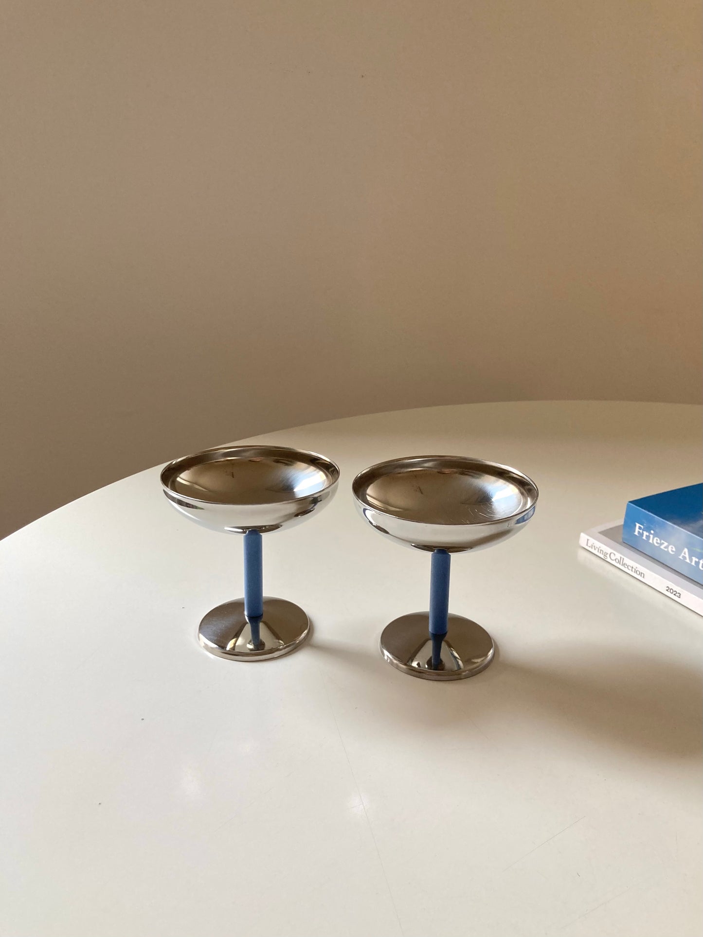 Set of steel cups with blue stem