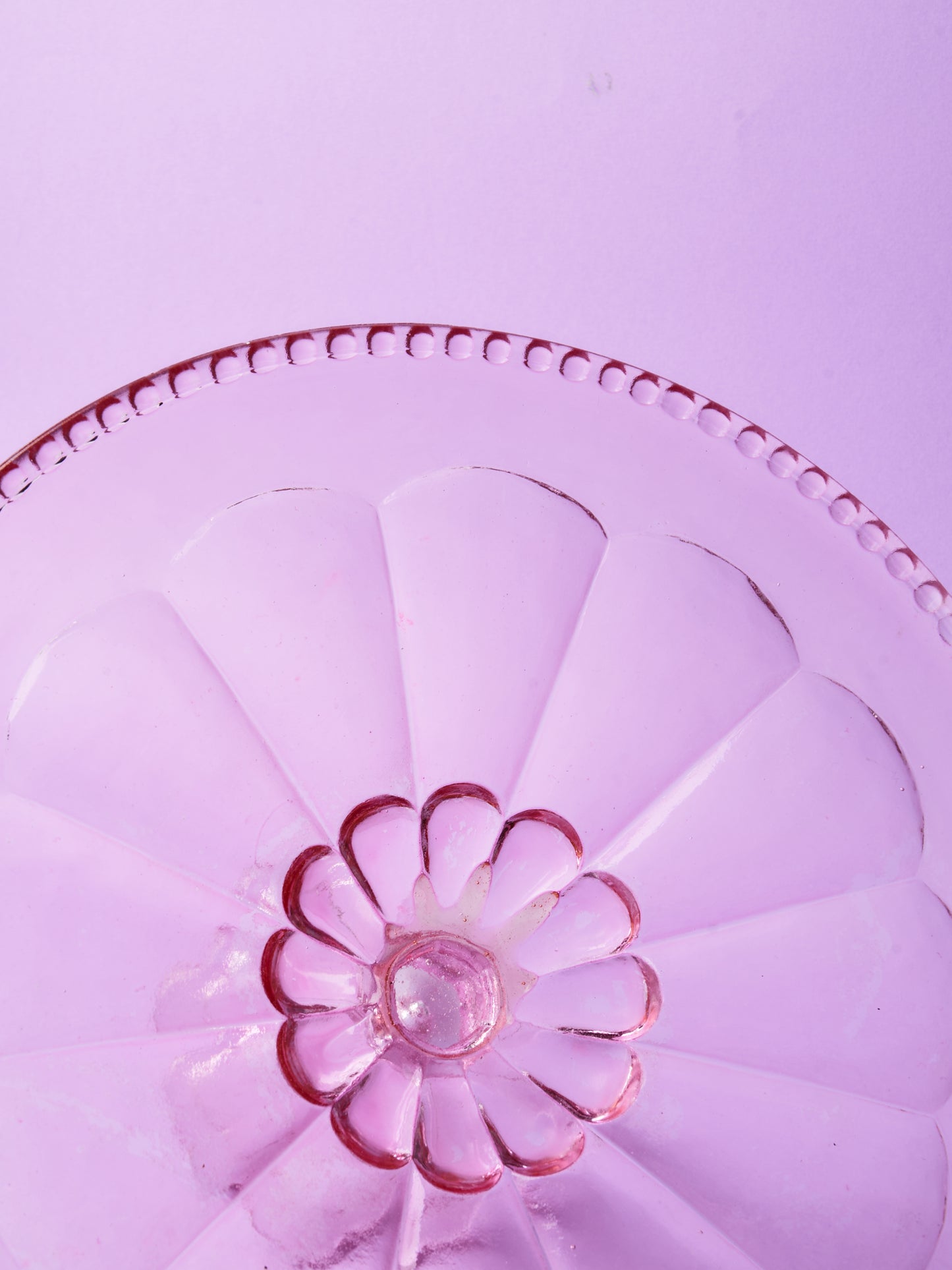 Pink glass cake stand with petal motif