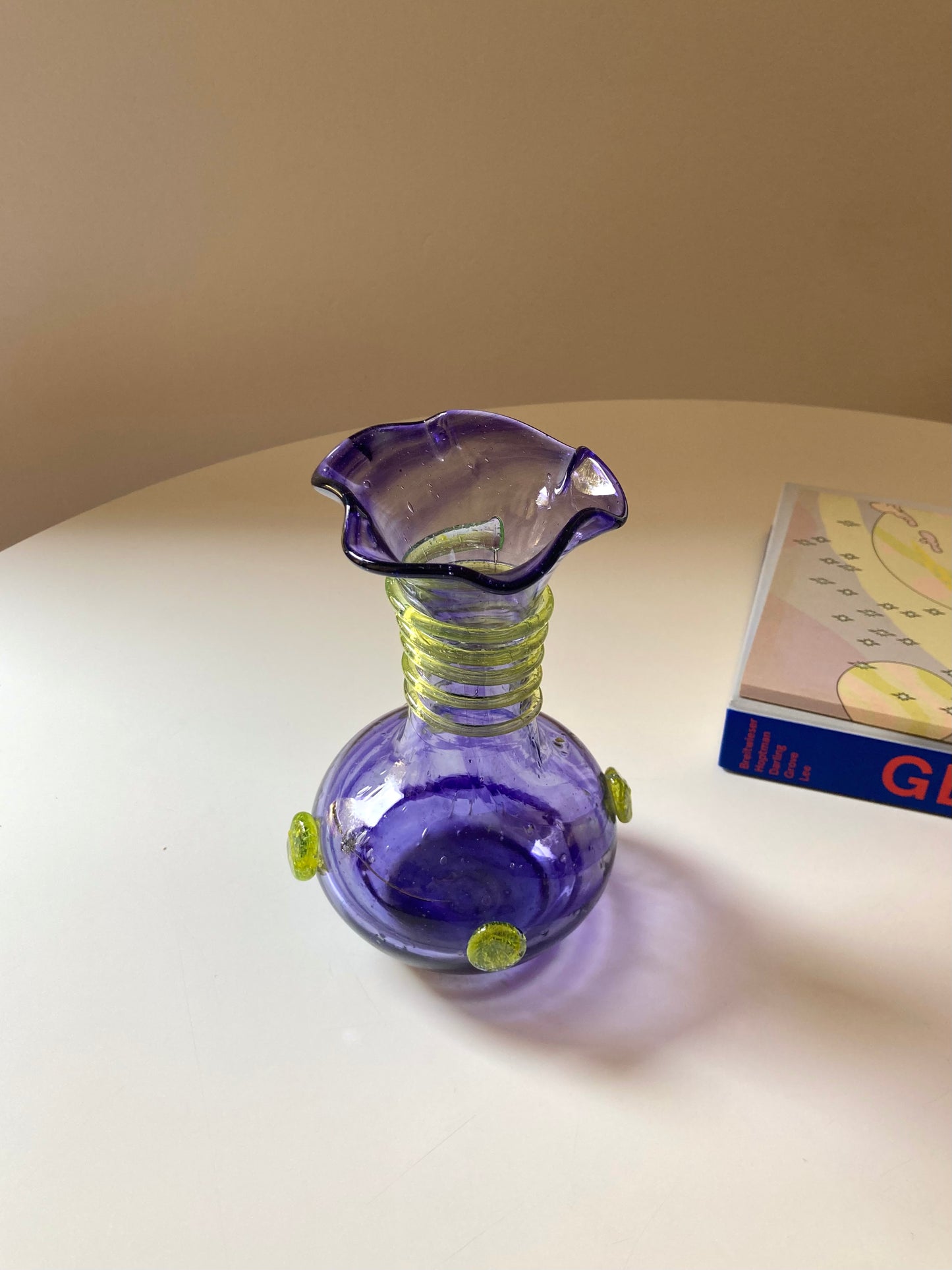 Vintage purple glass vase with green decorations