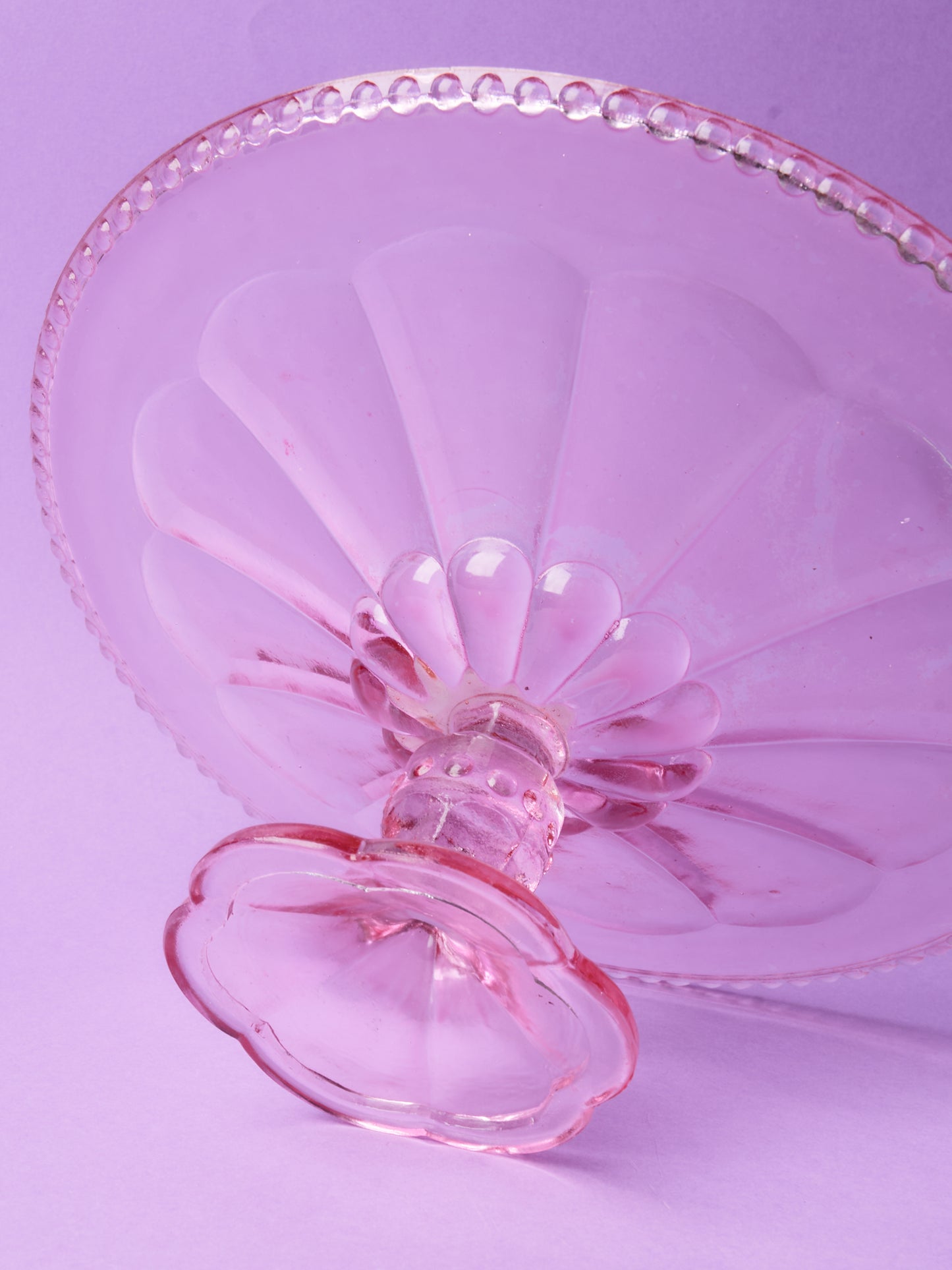 Pink glass cake stand with petal motif