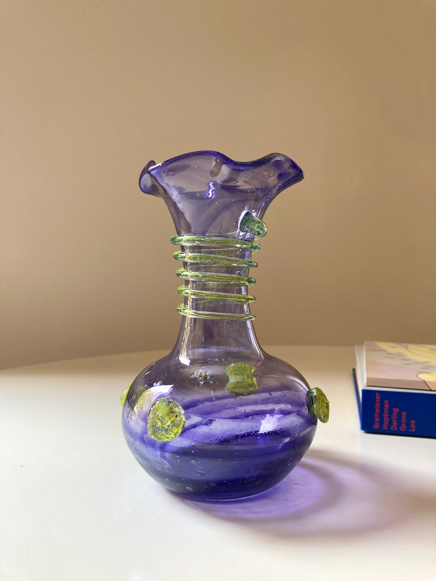 Vintage purple glass vase with green decorations