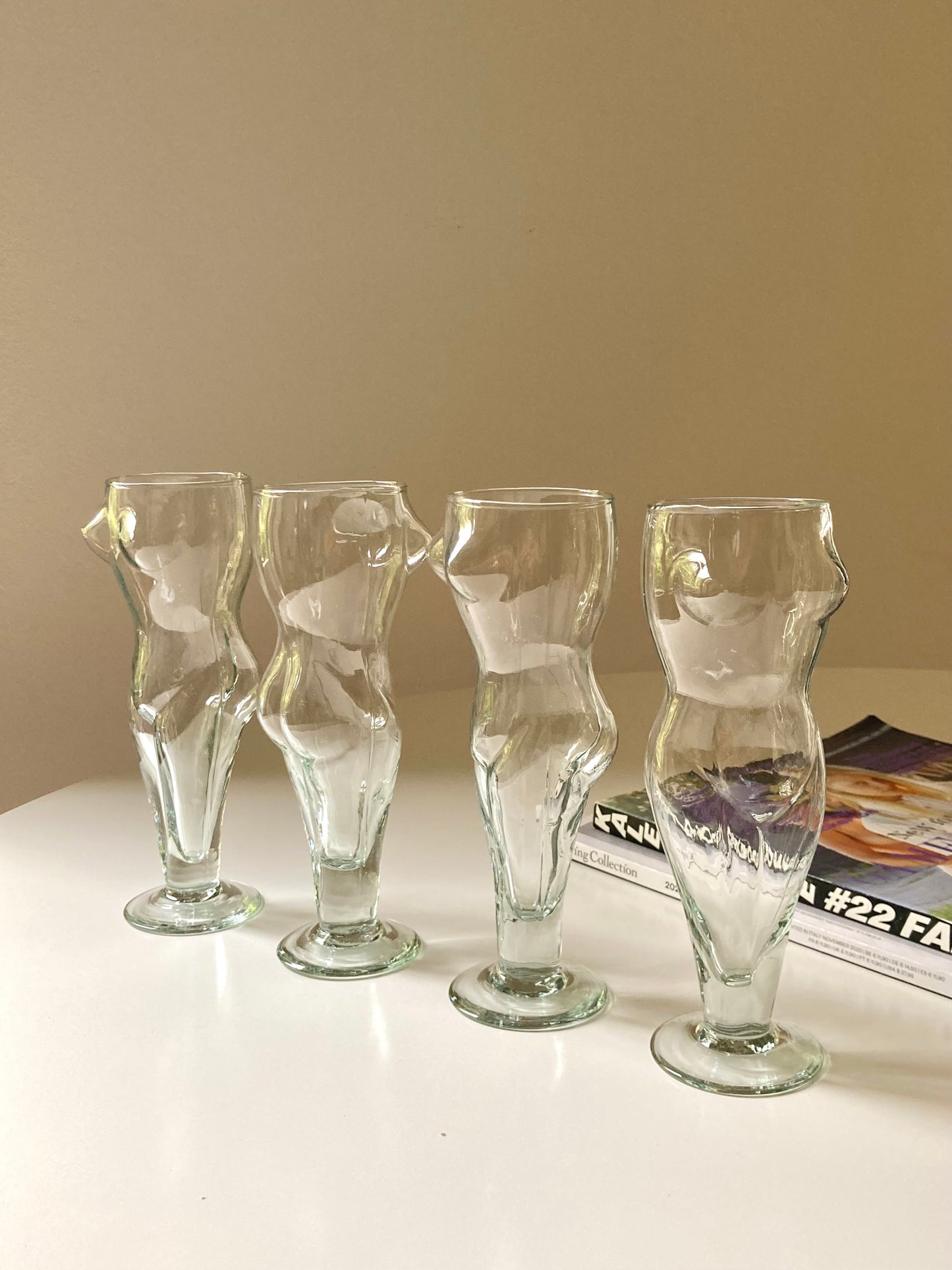 Tall glasses in the shape of a female body