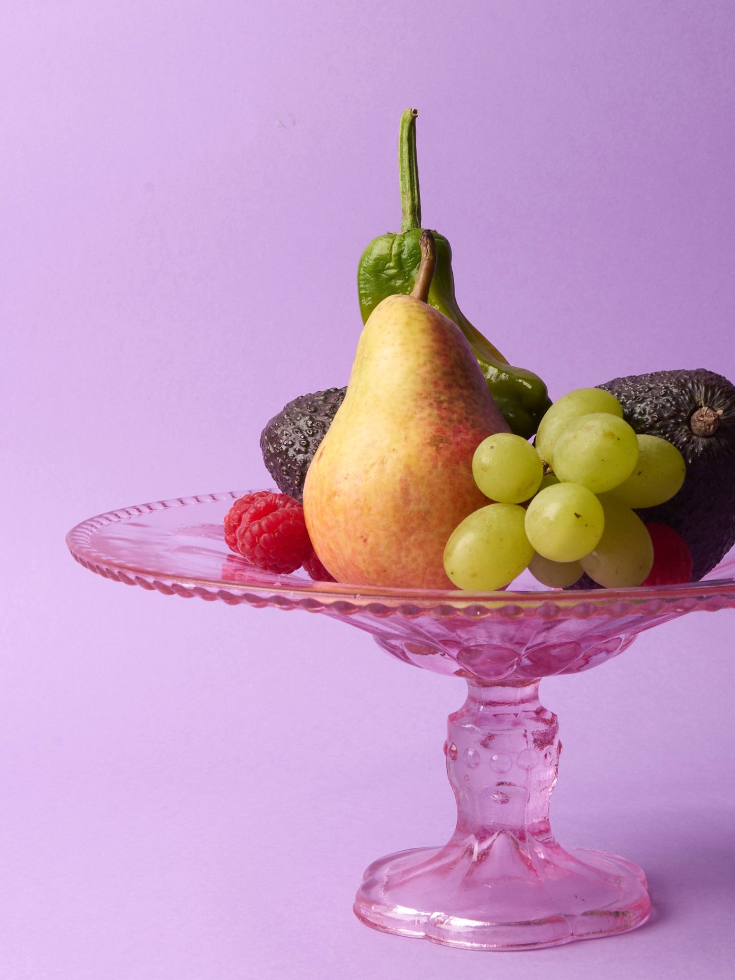 Pink glass cake stand with petal motif