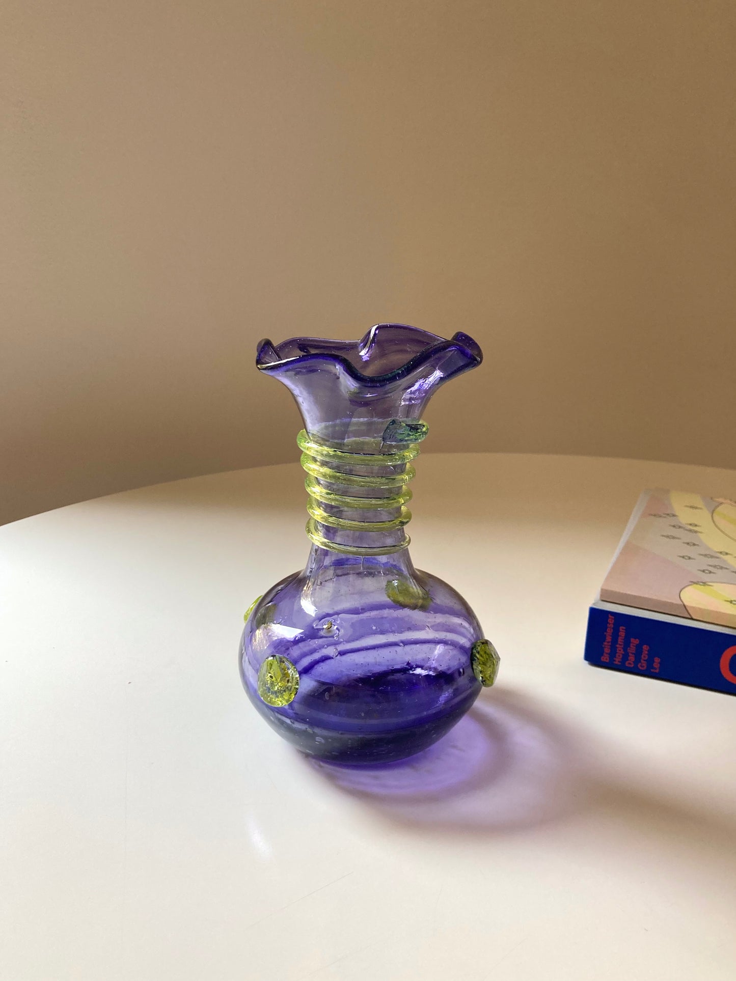 Vintage purple glass vase with green decorations