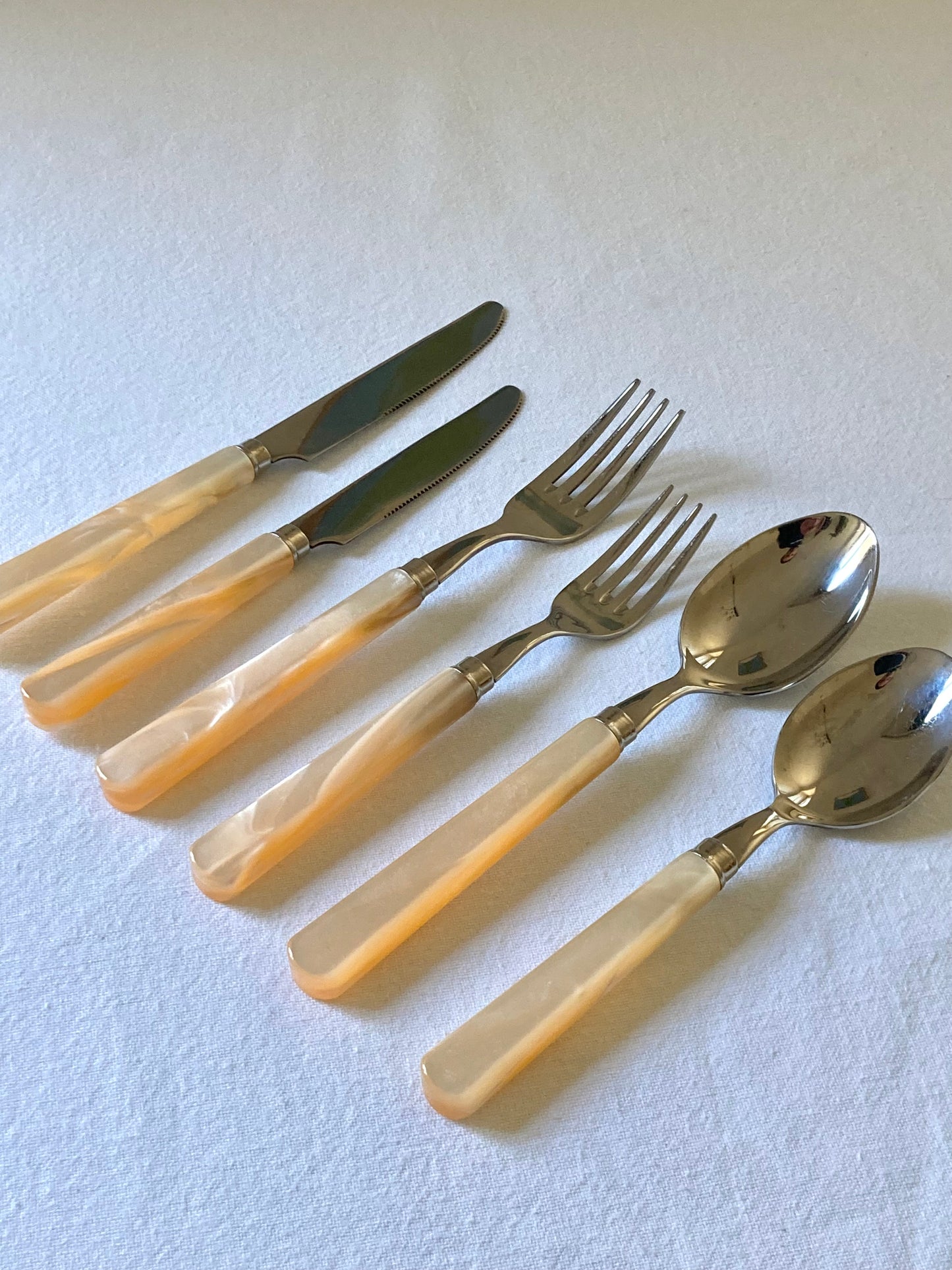 Pearly ivory colored table cutlery and dessert service