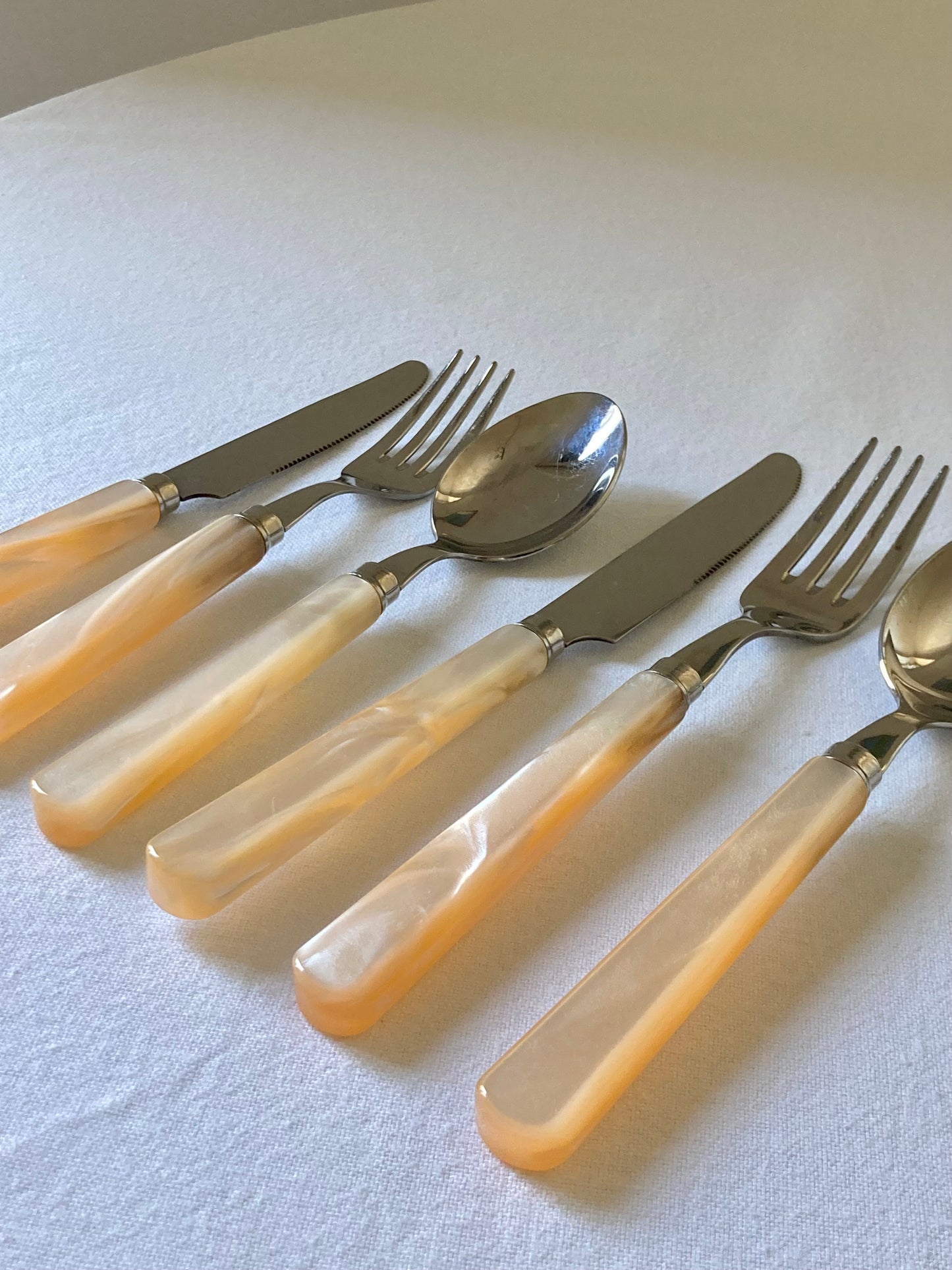 Pearly ivory colored table cutlery and dessert service