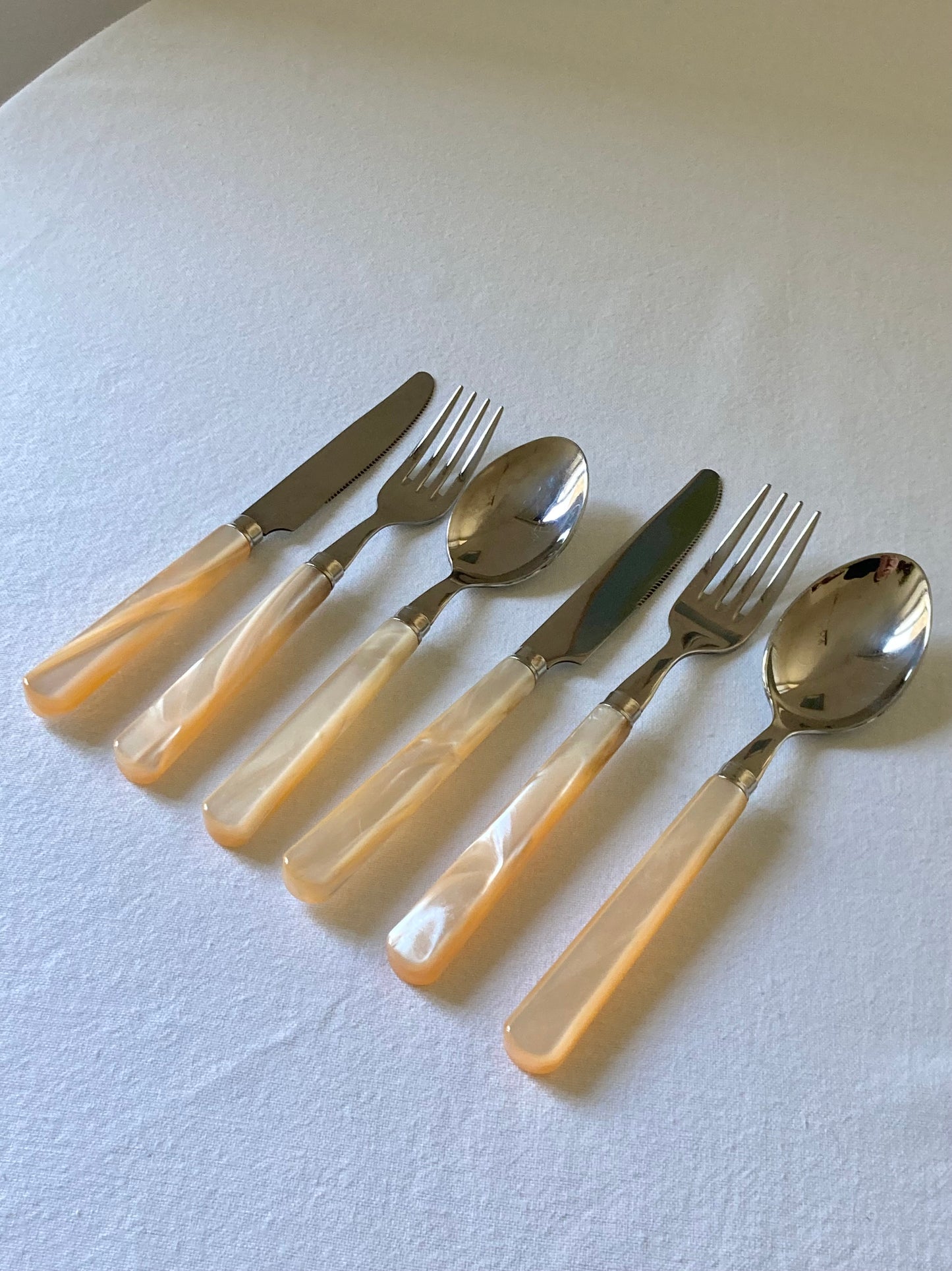 Pearly ivory colored table cutlery and dessert service