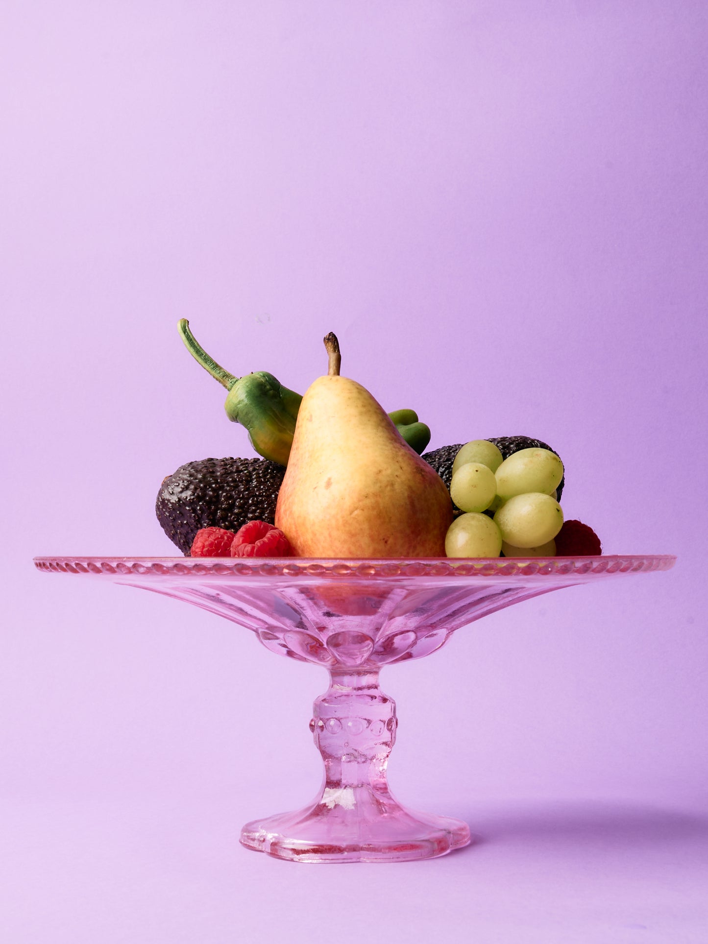 Pink glass cake stand with petal motif