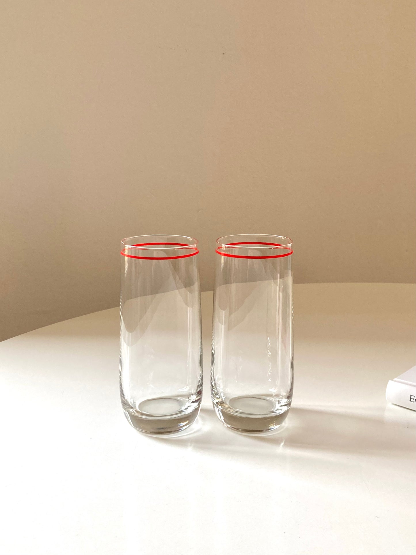 Pair of tall glasses with shaker