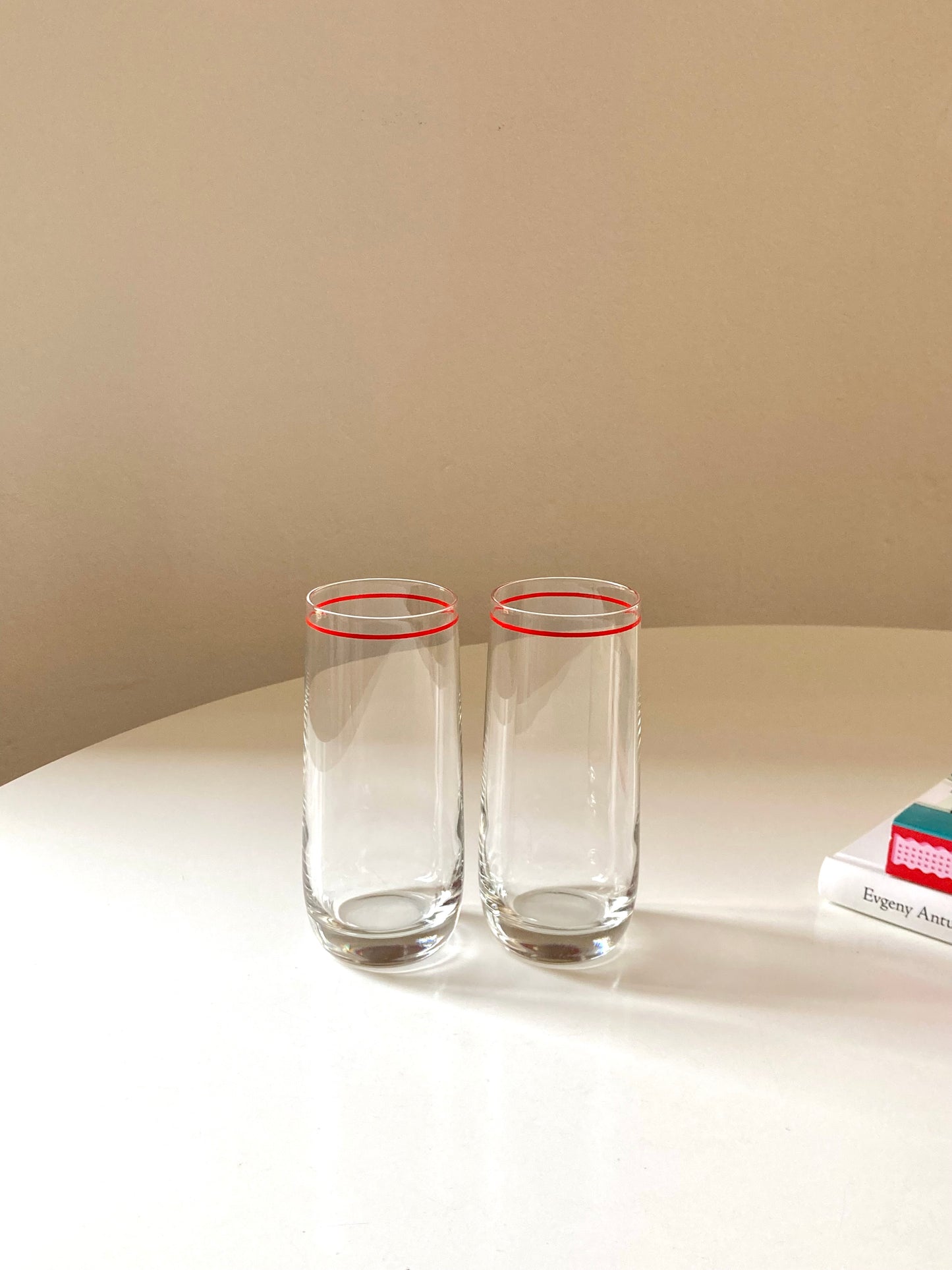 Pair of tall glasses with shaker