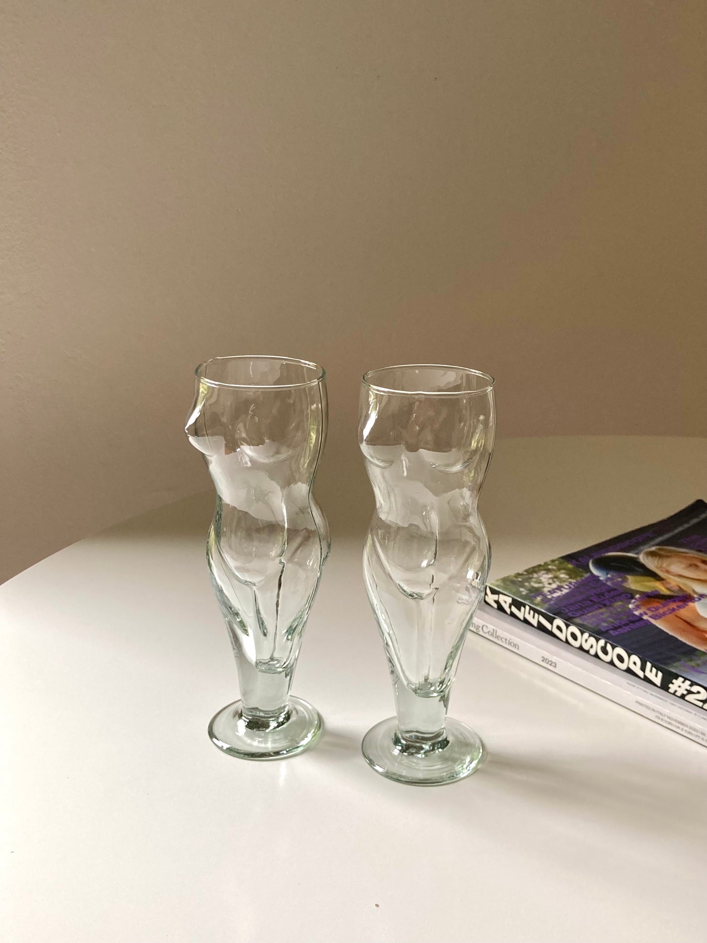 Tall glasses in the shape of a female body