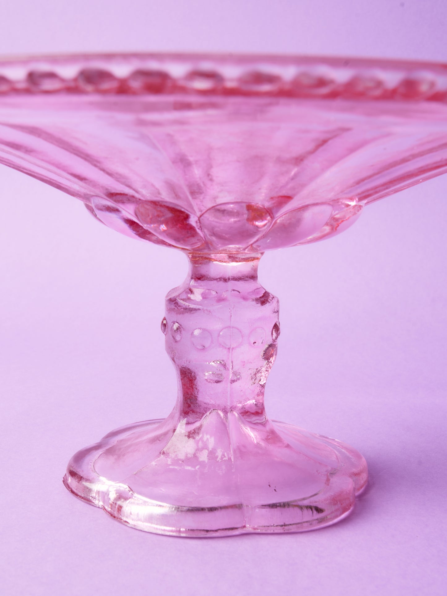 Pink glass cake stand with petal motif